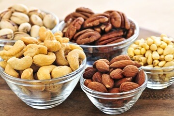 verschiedene Nüsse unter anderem Cashewnüsse, Pekannüsse und Mandeln. 
